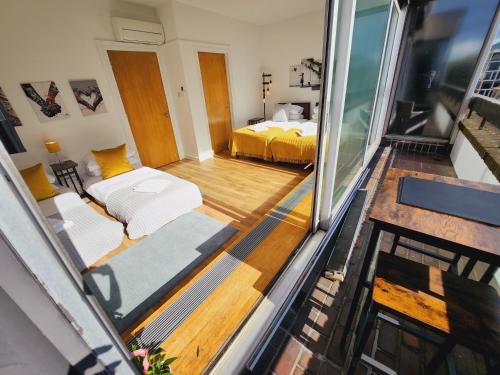 a view of a room with a bed and a balcony at Top Floor Room in Baker St in London