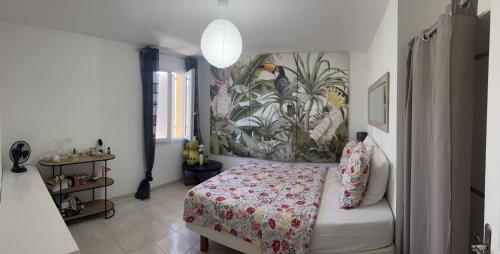 a bedroom with a bed with a floral bedspread at Villa Provençal in La Roque-dʼAnthéron