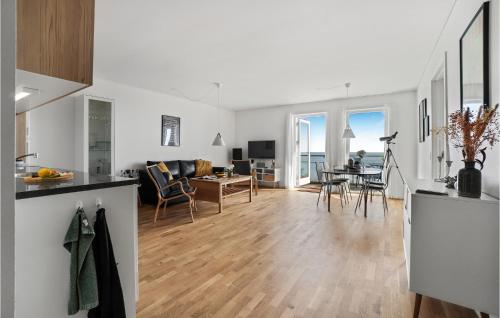 a kitchen and living room with white walls and wooden floors at Awesome Apartment In Allinge With Wifi in Allinge