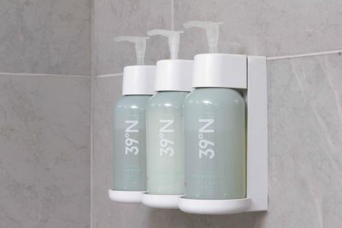 a group of three bottles of liquid in a bathroom at Courtyard Monterrey Airport in Monterrey