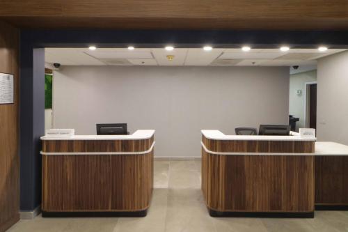 an office with two reception desks and a large wall at Courtyard Monterrey Airport in Monterrey