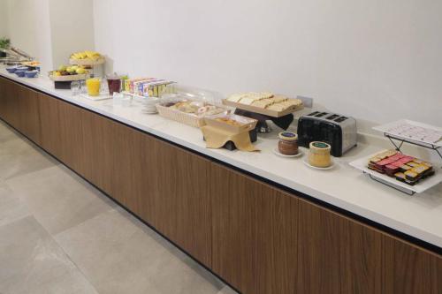 a buffet line with pastries and drinks on it at Courtyard Monterrey Airport in Monterrey