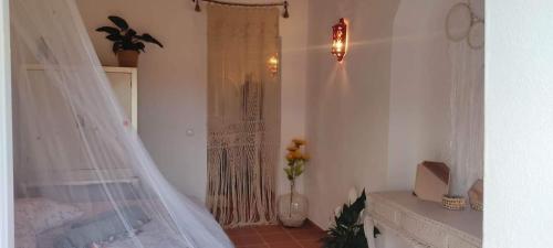a bedroom with a bed with a mosquito net at Herdade da Maceira in São Luis