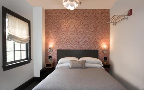 a bedroom with a large bed and a window at The Poppy Georgetown Guesthouse and Gardens in Washington