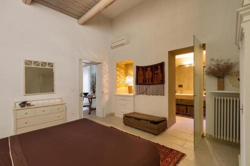 a bedroom with a bed and a sink and a mirror at Garibaldi Luxury in Otranto
