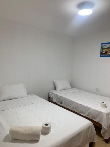 2 camas en una habitación con paredes blancas en BOCARENA, en Bocapán