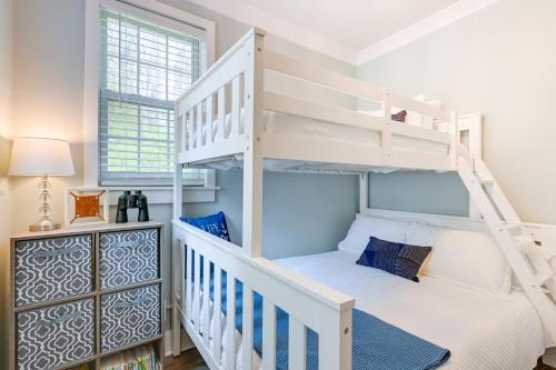ein weißes Etagenbett in einem Zimmer mit einer Treppe in der Unterkunft Beachy Palms Cottage on Lake Huron with Hot Tub! in Palms