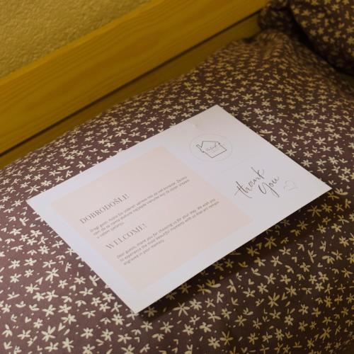 a invitation to a wedding on a bed at Vikendica Farah 