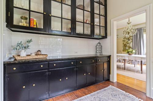 a kitchen with a large black cabinet in a room at Luxury Farmhouse in the Heart of Historic Downtown in Cartersville