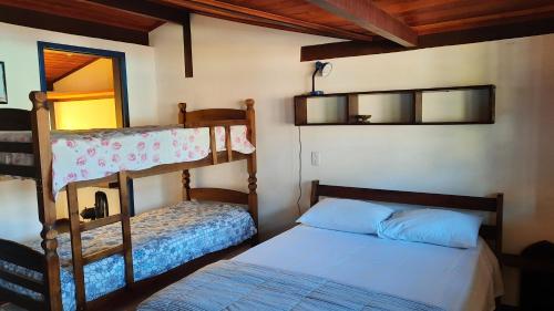 a bedroom with two bunk beds and a bed at Pousada Ora Pro Nobis in Catas Altas