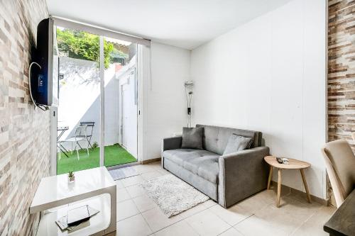 a living room with a couch and a window at Lisboa Charming Apartment III in Lisbon