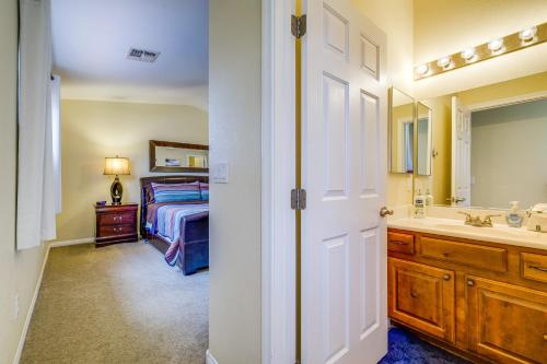a bedroom with a bed and a sink and a mirror at Mesquite Vacation Rental with Pool Access! in Mesquite