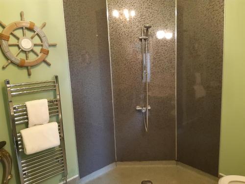 a bathroom with a shower with a wheel on the wall at Holywell House in Loughborough