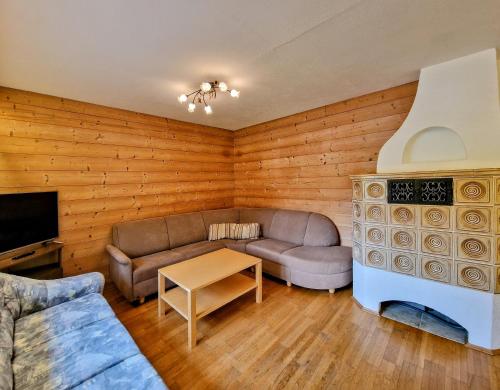 a living room with a couch and a table at Ferienhaus Alpenschlössl in Lermoos