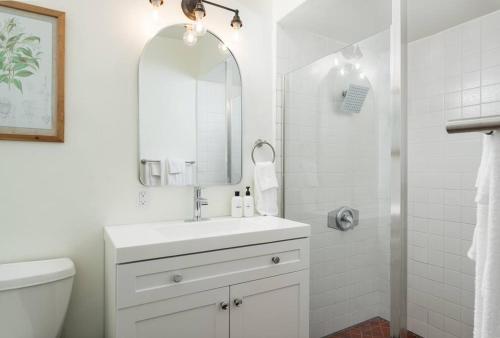 Baño blanco con lavabo y espejo en Casa Blanca Suite B2 - New, Private, Cozy! en Montecito