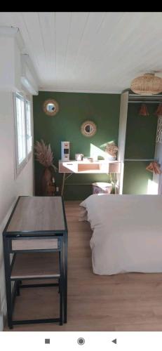 a room with a bed and a table in it at Studio indépendant au calme in Angers
