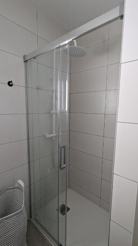 a shower with a glass door in a bathroom at Ona Beach daimuz in Daimuz