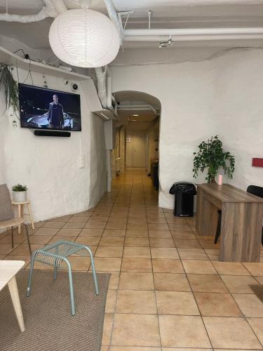 an empty room with a tv on the wall at Nomad Cave in Stockholm