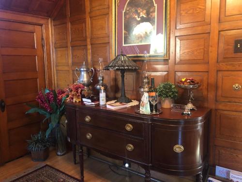 a wooden room with a dresser with a lamp on it at The Pembrooke Inn in Sturgeon Bay