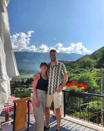 a man and a woman standing on a balcony at Castle Hotel in Gjirokastër
