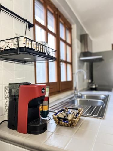 a kitchen counter with a coffee maker and a basket of food at Villa SALMAGI - Sardegna in Terra Mala