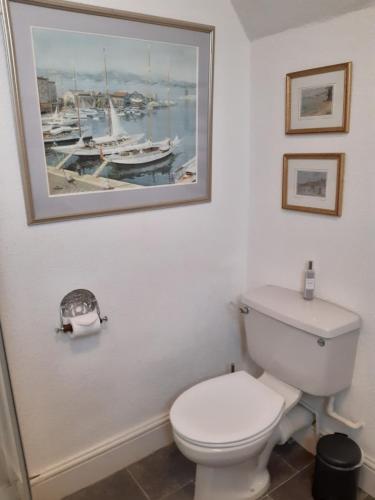a bathroom with a toilet and a picture on the wall at Holywell House in Loughborough