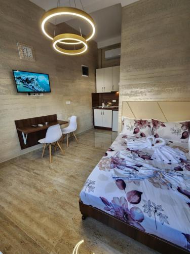 a bedroom with a bed and a desk and a table at Ebra Lux Apartmani in Dobra Voda