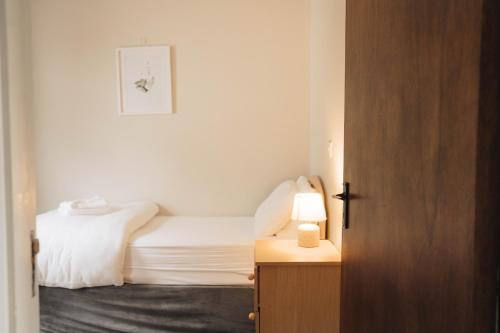 a small bedroom with a bed and a lamp on a table at Donegal Estuary Holiday Homes in Donegal