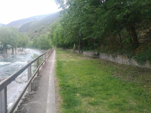 a path next to a river next to a fence at APARTAMENT BETTY in Sort