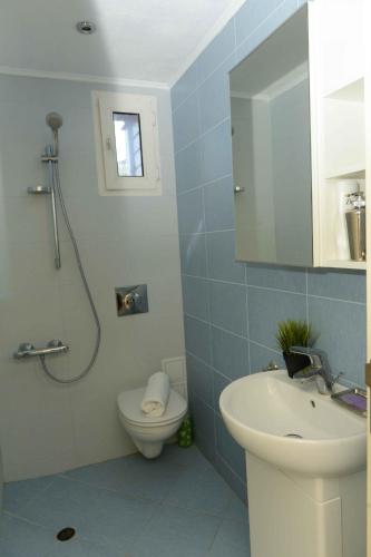 a bathroom with a shower and a toilet and a sink at Villa MIA Sozopol in Sozopol