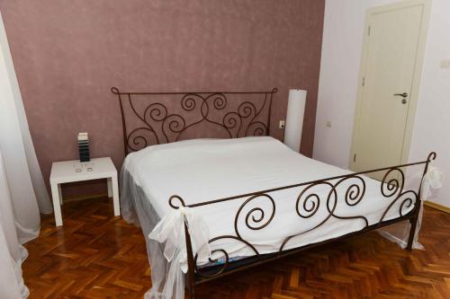 a bedroom with a bed with white sheets and a table at Villa MIA Sozopol in Sozopol