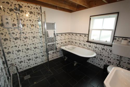 a bathroom with a sink and a shower at Easdale Cottage in Ellanbeich