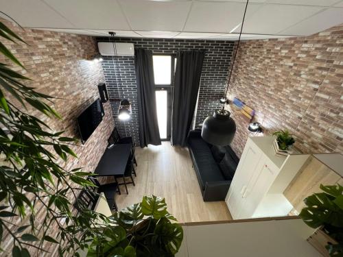 salon na otwartym planie z ceglaną ścianą w obiekcie Grandera Apart`s - Melià i Fuster 23С w Walencji