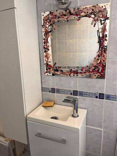 a bathroom with a sink and a mirror at Centre ville de Nevers. in Nevers