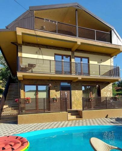 a house with a swimming pool in front of it at Villa Marina in Ohrid