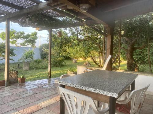 a table and chairs on a patio with a view at VILLA ENA in Torre dell'Orso