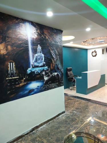 an office with a large painting on the wall at Hotel Sai Dakshina Inn & The Fern Restaurant in Shirdi