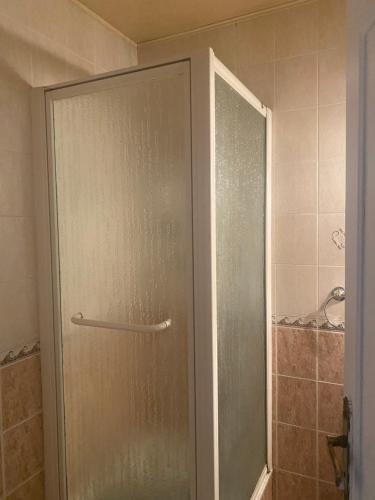 a shower with a glass door in a bathroom at Chambre cour in Fontaine