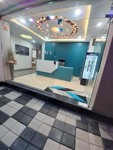 a lobby with a large clock hanging from the ceiling at Hotel Sai Dakshina Inn & The Fern Restaurant in Shirdi