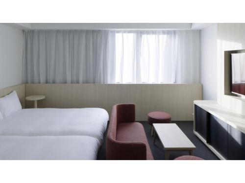 a hotel room with a bed and a chair at SOKI KANAZAWA - Vacation STAY 40338v in Kanazawa