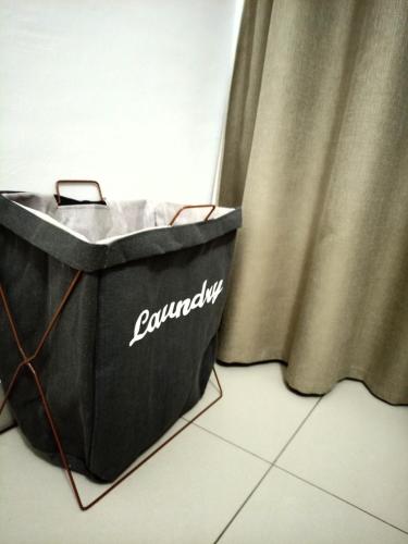 a black bag sitting on the floor next to a curtain at Olive Exclusive in Gaborone