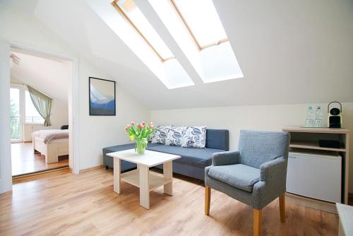 a living room with a blue couch and a table at Willa Pod Lasem in Tupadły