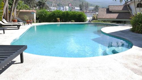 una piscina de agua azul en un patio en Hotel Hacienda las Higueras, en Tepic