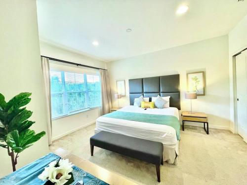 a bedroom with a large bed and a large window at AMAZING vacation house .Mins to Disney Regal oasks in Orlando