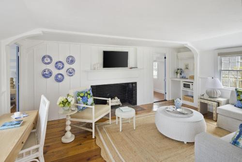 a living room with blue and white plates on the wall at White Elephant Hotel in Nantucket