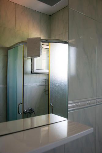 a bathroom with a glass window and a shower at Luce di Sole Apartment in Sveti Nikola