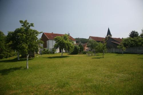 a yard with houses and trees and a church at Domaine La Bonne Dame - Hirondelle, au coeur des Vosges in Plainfaing