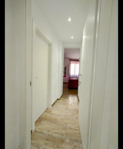 a hallway with white walls and a tile floor at Panta Rei in Lamezia Terme