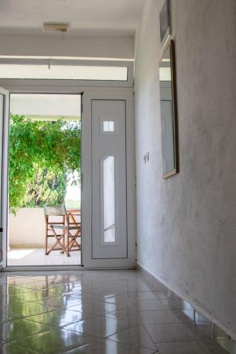 an open door leading to a patio with a chair at Luce di Sole Apartment in Sveti Nikola