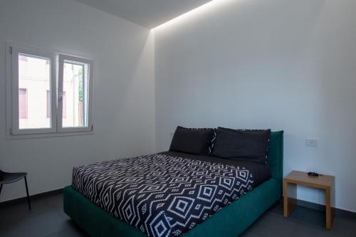 a bedroom with a bed and a window at Il Giardino Antico in Agrigento